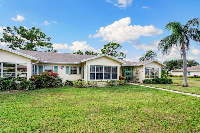 ranch-style home featuring a front yard