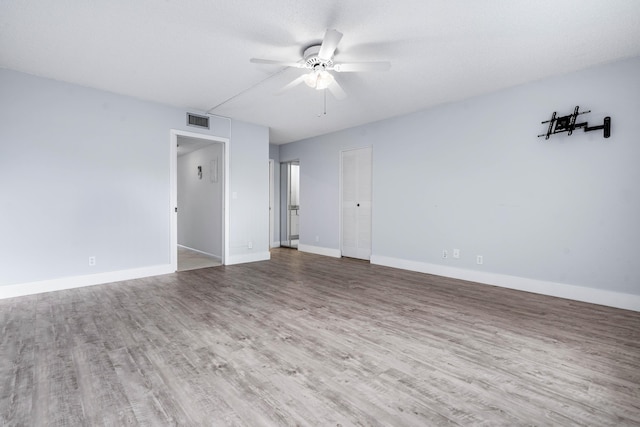 empty room featuring hardwood / wood-style flooring and ceiling fan