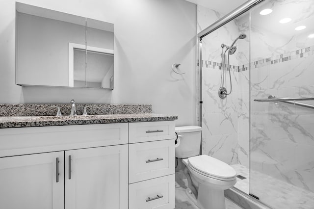 bathroom featuring vanity, toilet, and walk in shower