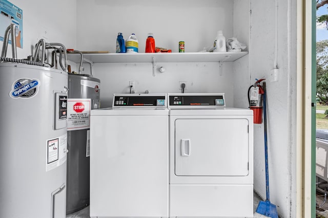 washroom featuring electric water heater, washing machine and dryer, and water heater