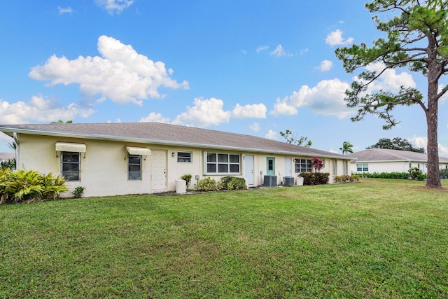 view of front of home with central air condition unit and a front lawn