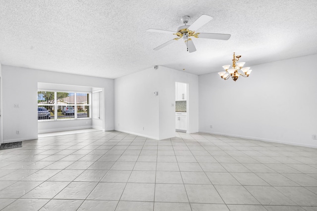 interior space featuring ceiling fan with notable chandelier, light tile patterned floors, and a textured ceiling