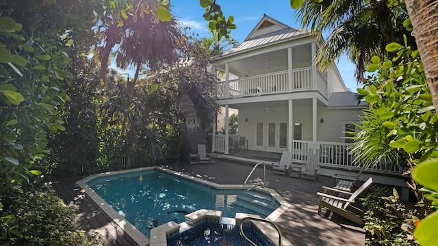 view of swimming pool with ceiling fan and a wooden deck