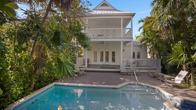 back of house featuring ceiling fan, a deck, and a balcony