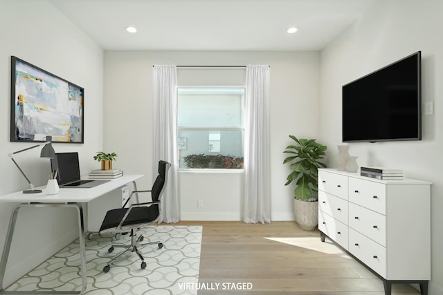 office area with light hardwood / wood-style floors