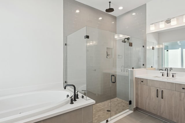 bathroom with tile patterned floors, vanity, and plus walk in shower