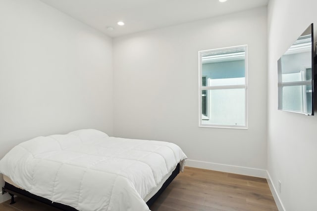 bedroom with hardwood / wood-style floors