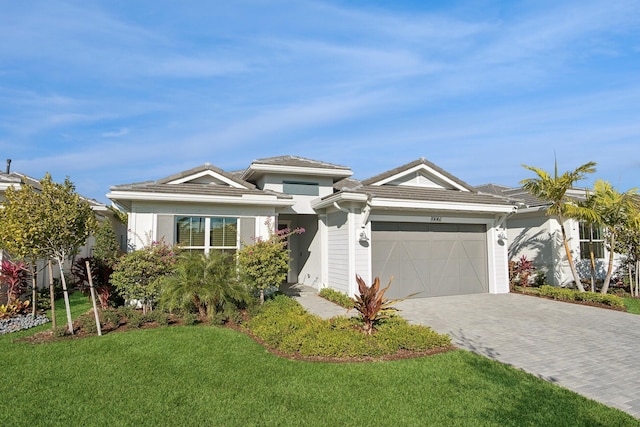 view of front facade with a garage and a front lawn