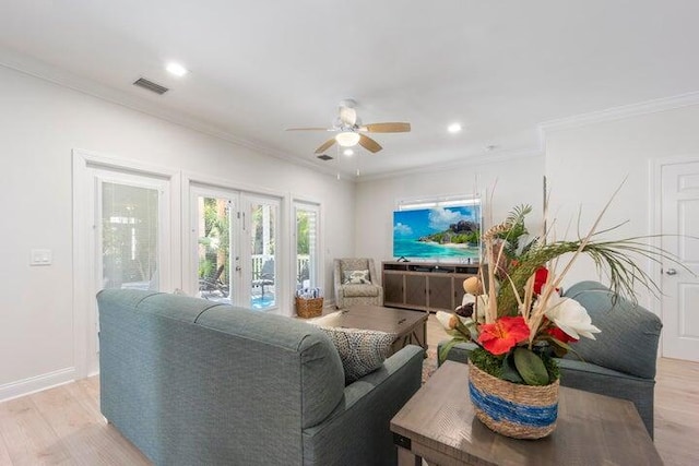 living room with ceiling fan, light hardwood / wood-style flooring, crown molding, and french doors