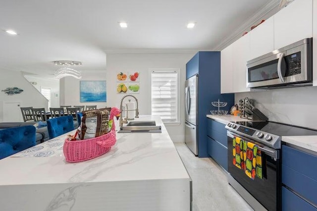 kitchen featuring white cabinets, sink, an island with sink, and stainless steel appliances