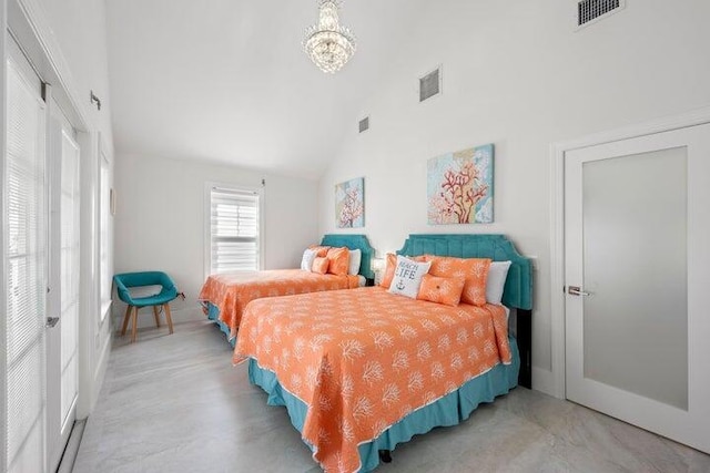 bedroom with lofted ceiling and a notable chandelier