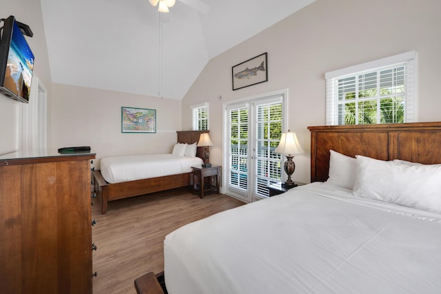 bedroom featuring ceiling fan, light hardwood / wood-style floors, vaulted ceiling, and access to exterior