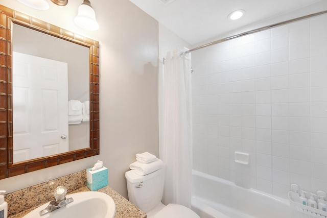 full bathroom featuring toilet, shower / bath combo with shower curtain, and sink