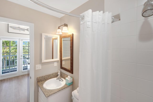 bathroom featuring hardwood / wood-style floors, a shower with shower curtain, and vanity