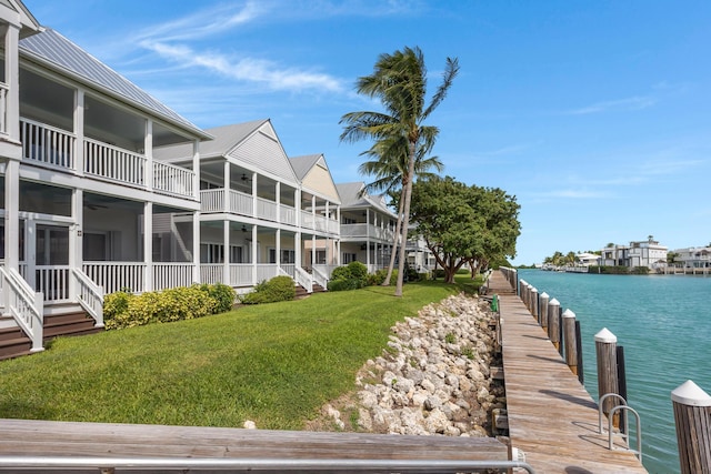 exterior space with a water view and a lawn