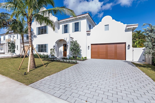 view of front facade with a garage and a front lawn