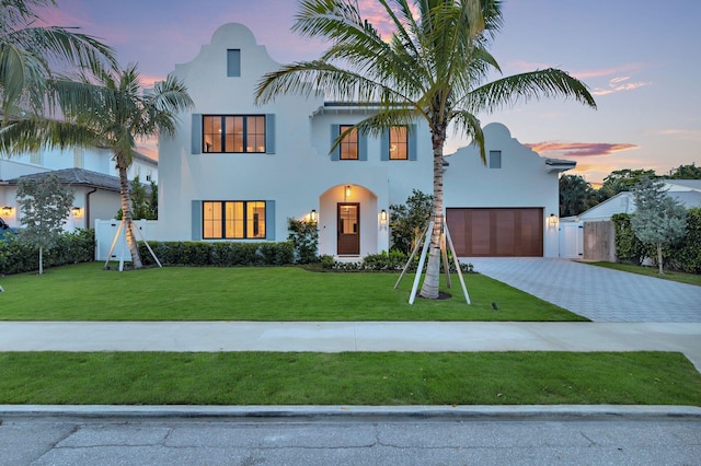 315 Avila Rd, West Palm Beach, FL 33405 - view of front of house with stucco siding, decorative driveway, a gate, and an attached garage