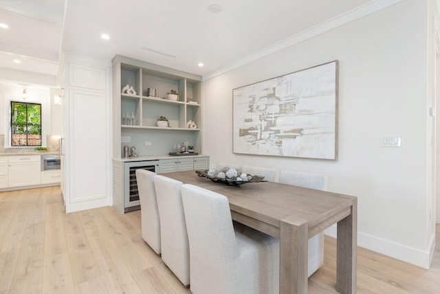 dining area with light wood-type flooring, wine cooler, and crown molding