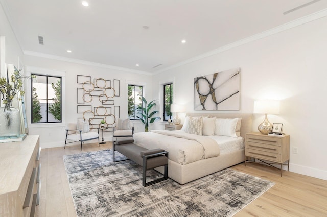 bedroom with light hardwood / wood-style flooring and crown molding