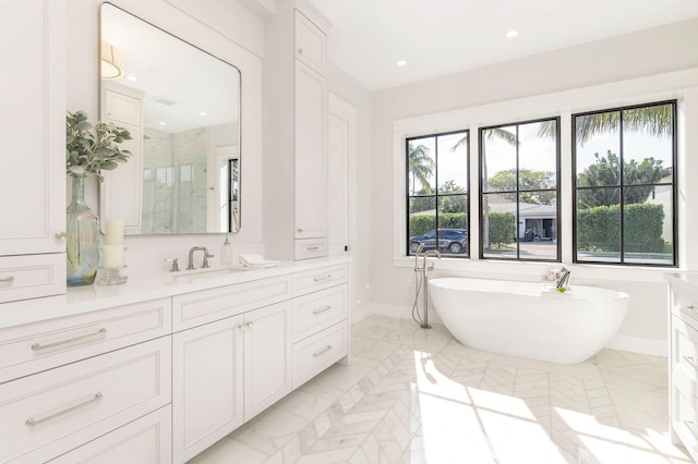 315 Avila Rd, West Palm Beach, FL 33405 - full bath featuring a stall shower, vanity, a freestanding tub, marble finish floors, and recessed lighting