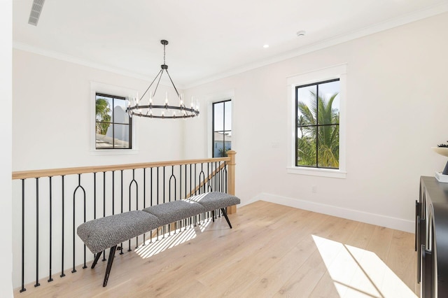 dining space with a notable chandelier, light hardwood / wood-style floors, and ornamental molding