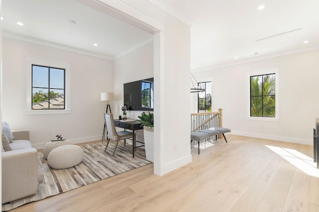 living room with light hardwood / wood-style flooring and ornamental molding