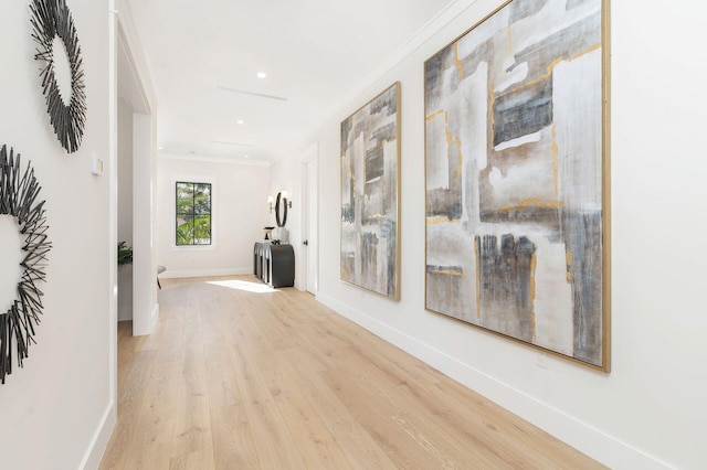 hall with crown molding and light hardwood / wood-style floors