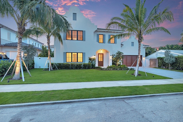 315 Avila Rd, West Palm Beach, FL 33405 - view of front facade featuring concrete driveway, a garage, stucco siding, and a gate
