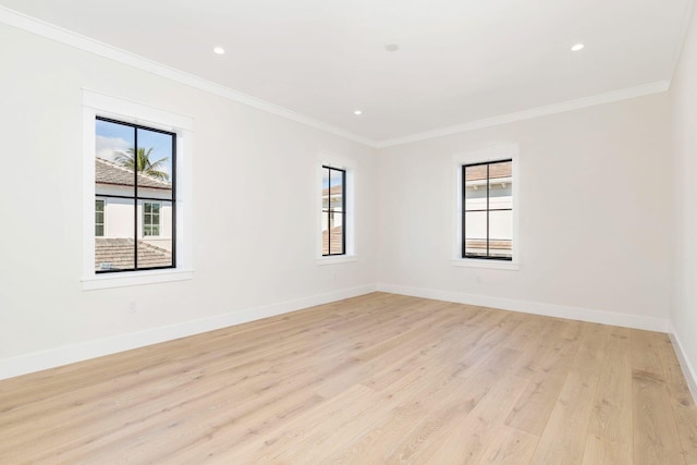 empty room featuring light hardwood / wood-style floors and crown molding