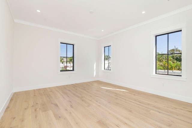 unfurnished room featuring light hardwood / wood-style floors and crown molding