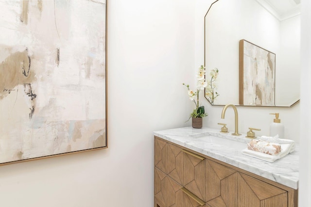 bathroom with vanity and ornamental molding