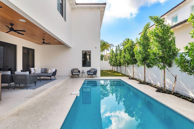 view of swimming pool featuring a patio area, ceiling fan, french doors, and an outdoor living space