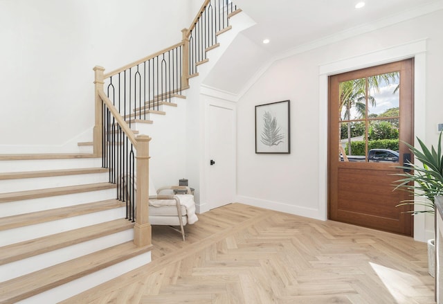 foyer entrance featuring parquet floors and crown molding