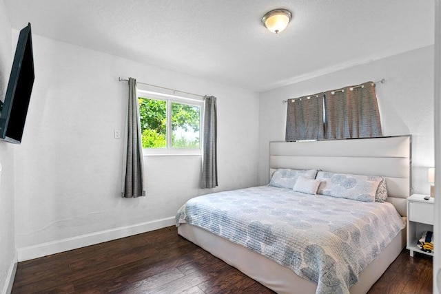 bedroom featuring dark hardwood / wood-style flooring