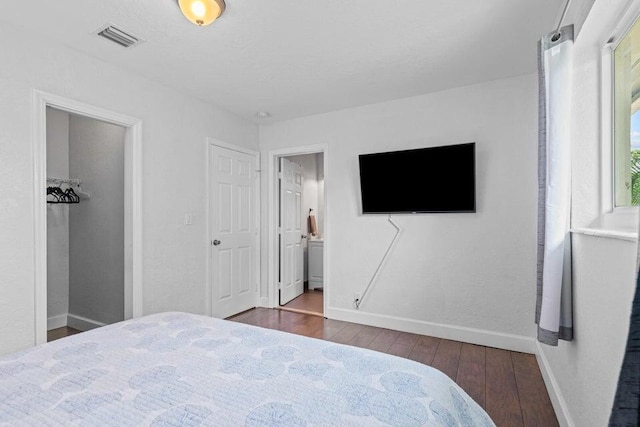 bedroom featuring dark hardwood / wood-style floors and ensuite bathroom