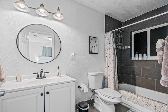 full bathroom featuring a textured ceiling, vanity, toilet, and shower / tub combo with curtain