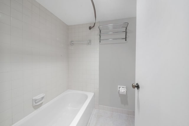 bathroom featuring tiled shower / bath combo and tile patterned floors