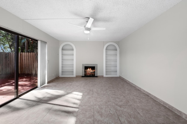 unfurnished living room featuring built in shelves, ceiling fan, a textured ceiling, and light tile patterned floors