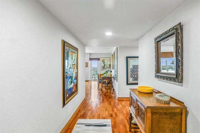 hallway featuring plenty of natural light and light wood-type flooring