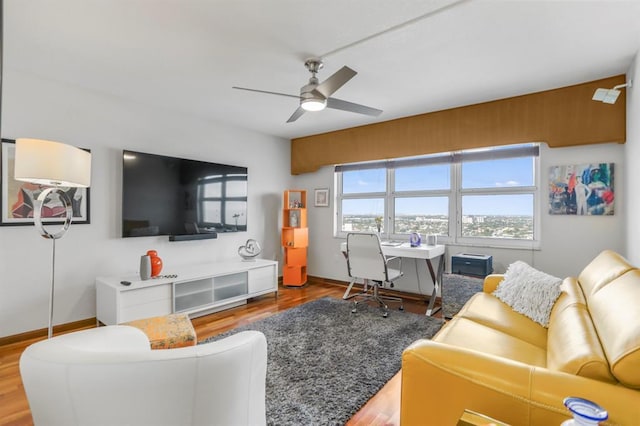 living room with wood-type flooring and ceiling fan