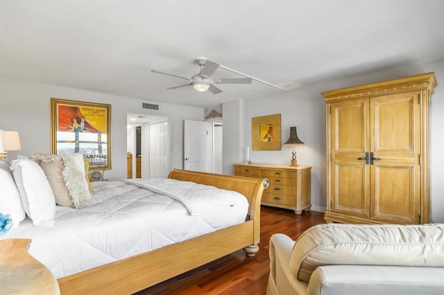 bedroom with ceiling fan and dark hardwood / wood-style flooring