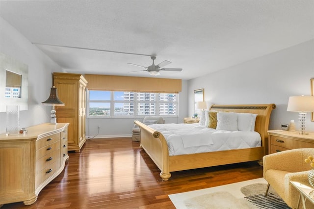 bedroom with ceiling fan and dark wood-type flooring