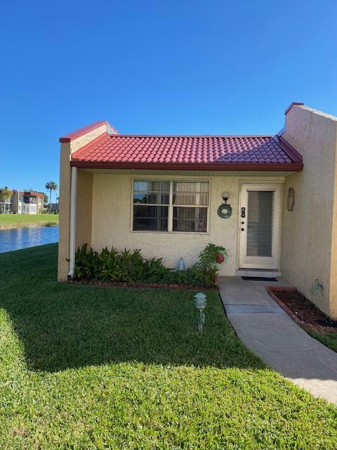 view of front of property with a water view and a front yard