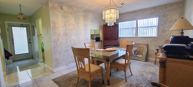 tiled dining room featuring a notable chandelier