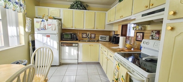 kitchen with white cabinetry, sink, white appliances, light tile patterned floors, and ornamental molding