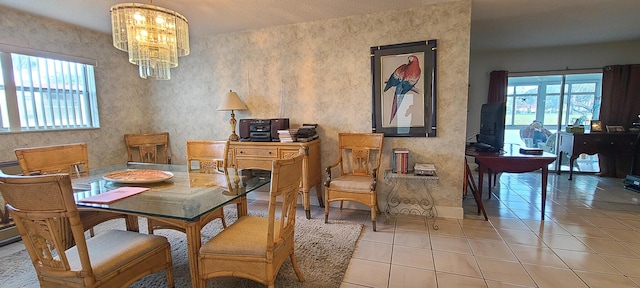 dining space with a healthy amount of sunlight, light tile patterned floors, and a chandelier