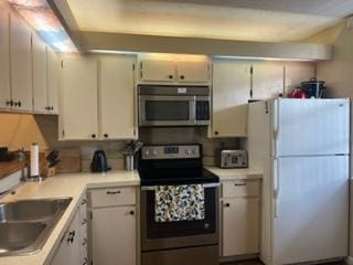 kitchen featuring sink, white cabinets, and stainless steel appliances