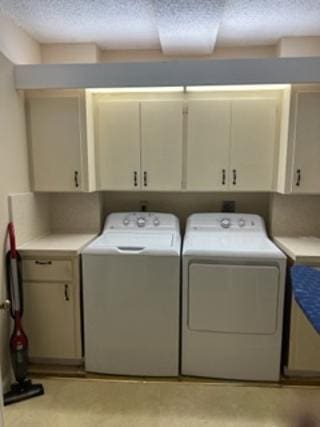 laundry area with cabinets and separate washer and dryer