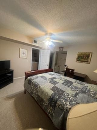 carpeted bedroom with a textured ceiling and ceiling fan