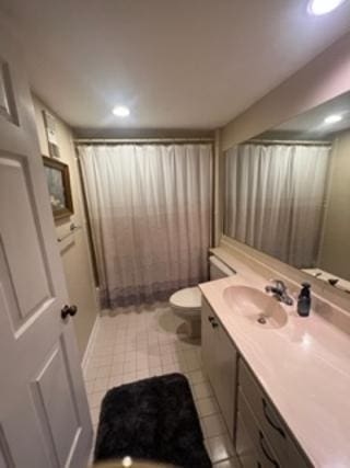 bathroom featuring toilet, a shower with curtain, vanity, and tile patterned floors